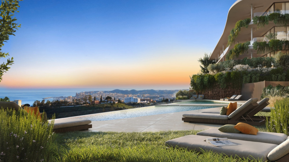Modern development in Fuengirola with infinity pool and panoramic views of the Mediterranean coast at sunset.